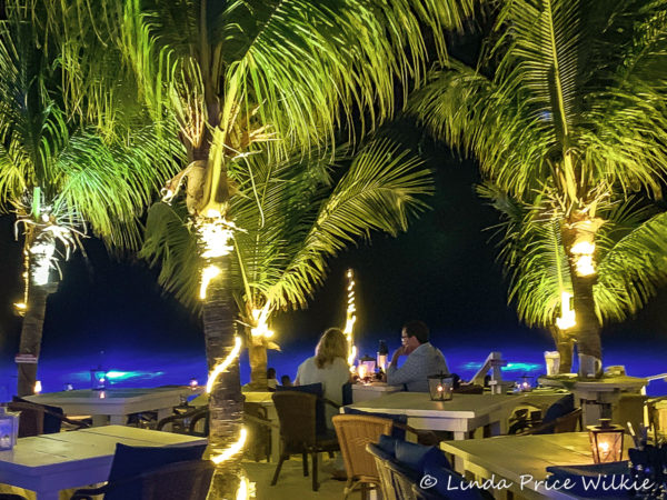 A photo of An intimate dinner on the upper beachside dining level away from the water's edge.
