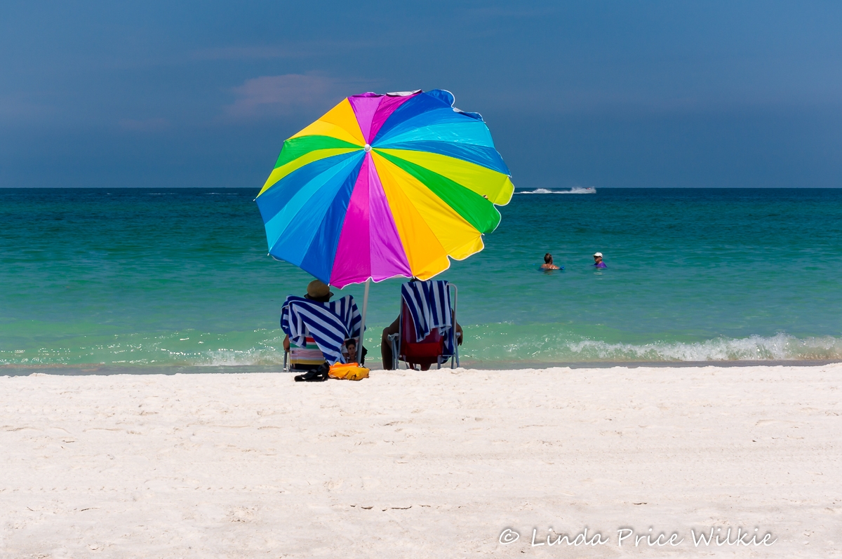Bright umbrellas decorate the beachscape at Bradenton Beach on Anna Maria Island, Florida.