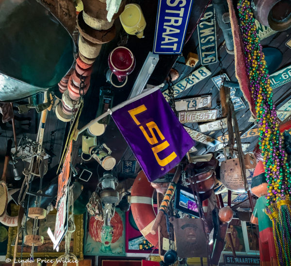 A photo of an LSU flag and Mardi Gras beads that stands out from the plethora of other memorabilia at Charlie's.