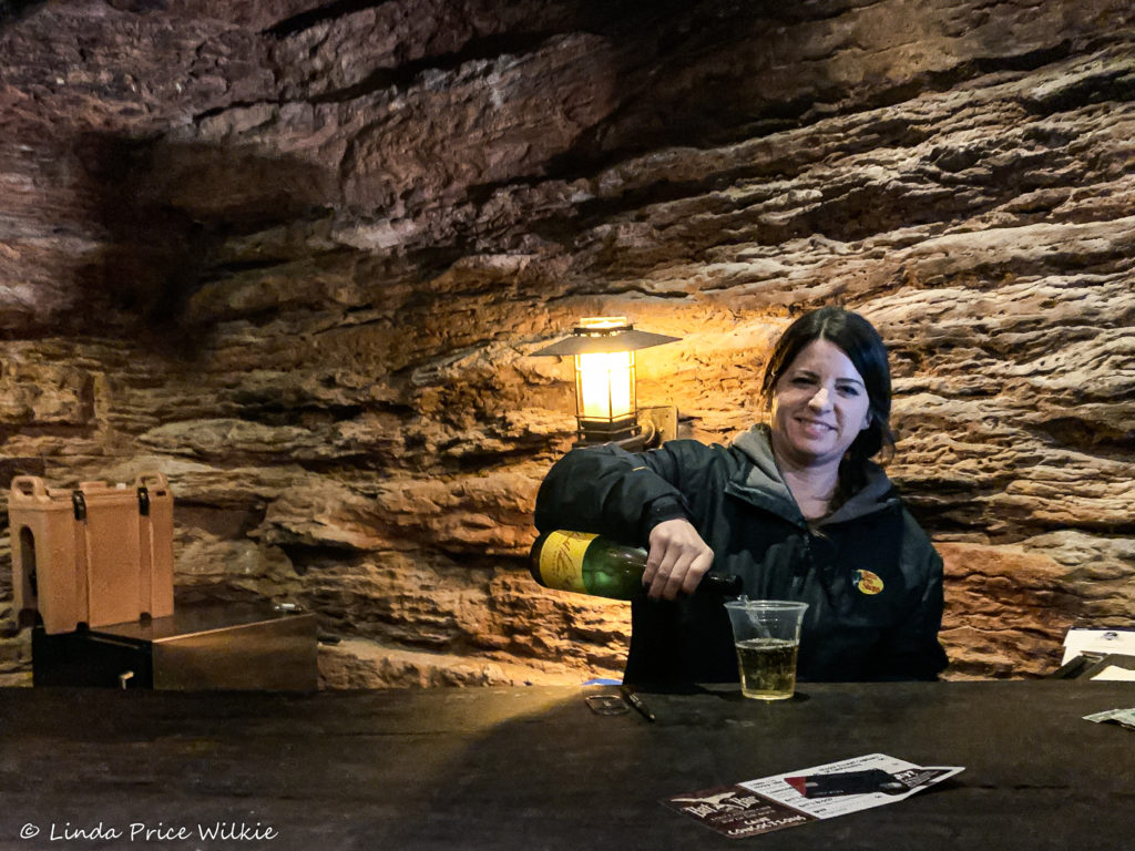 A photo of the bat bartender at Arnie's Bat Bar pouring a glass of Arnold Palmer Chardonnay.